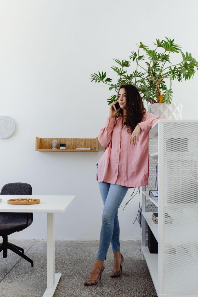 a woman standing while talking on her phone