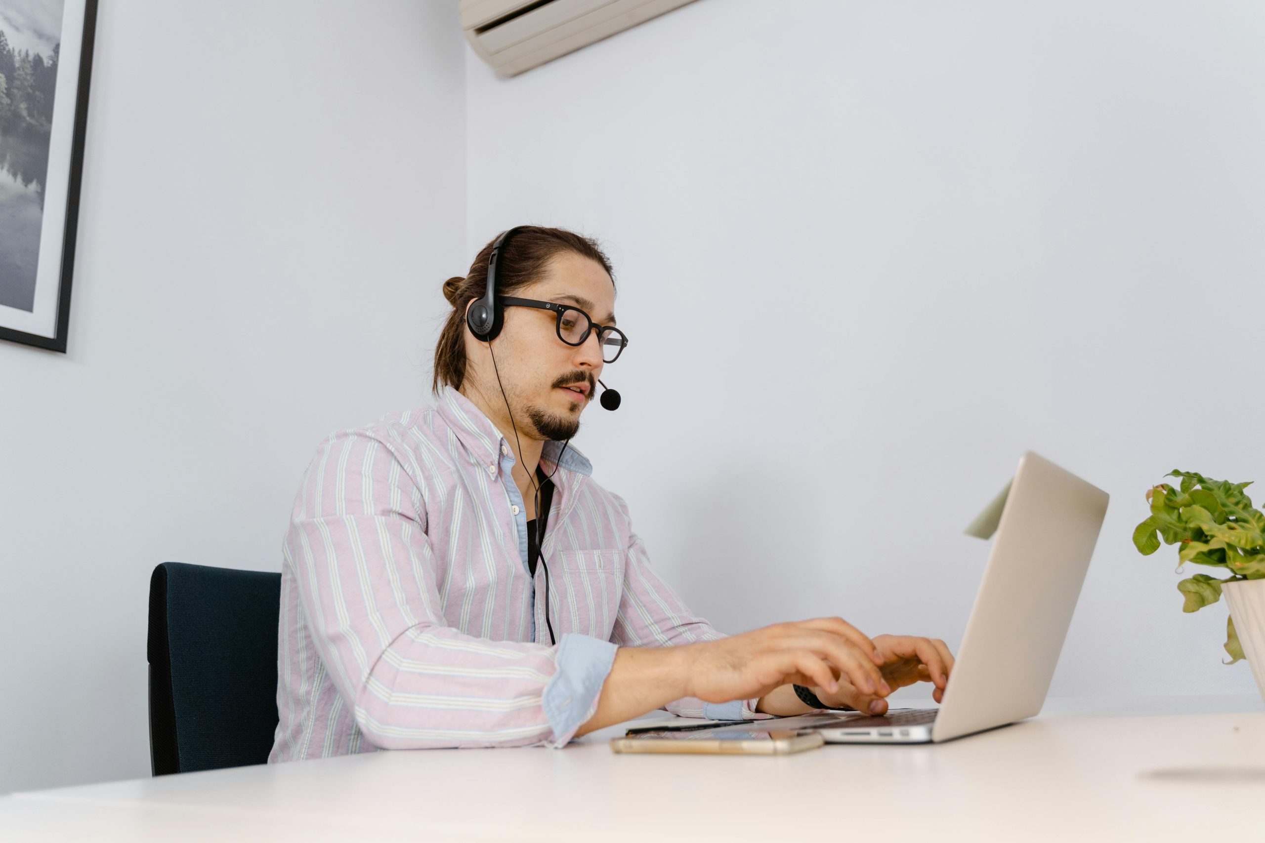 MSPs using a cloud phone system at a call center with headsets and laptops