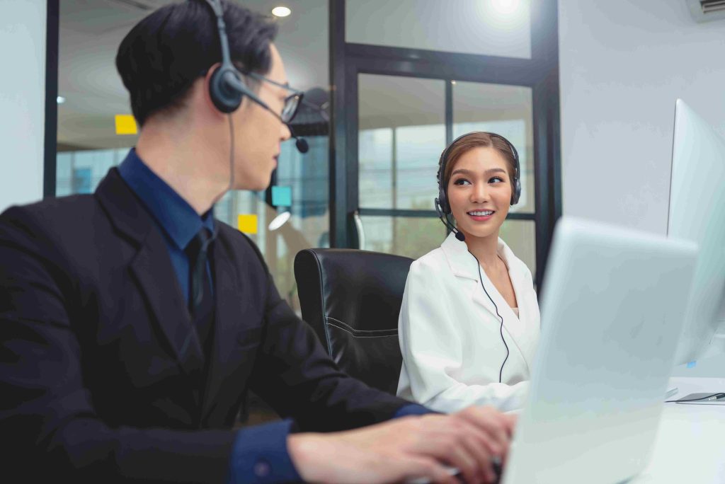 Business professional using the best VoIP for small business Canada at her desk.