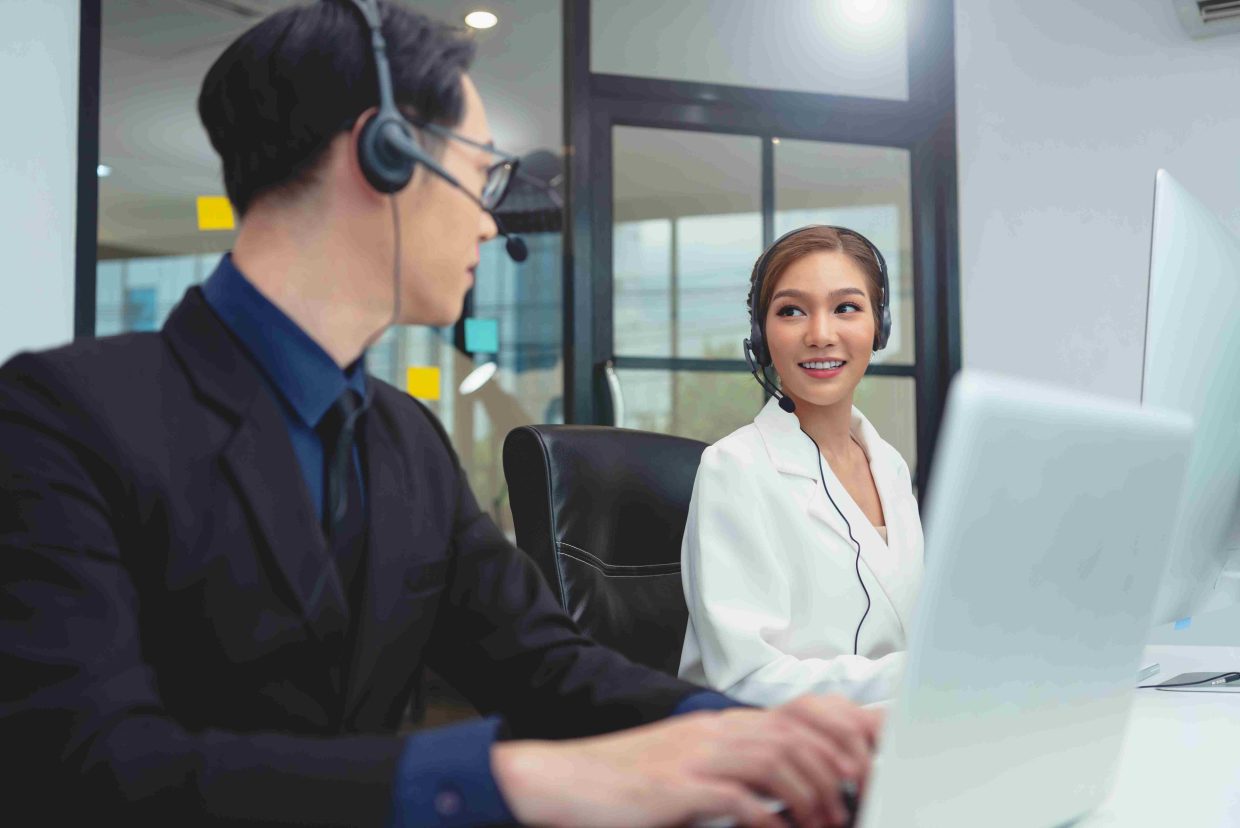 Business professional using the best VoIP for small business Canada at her desk.
