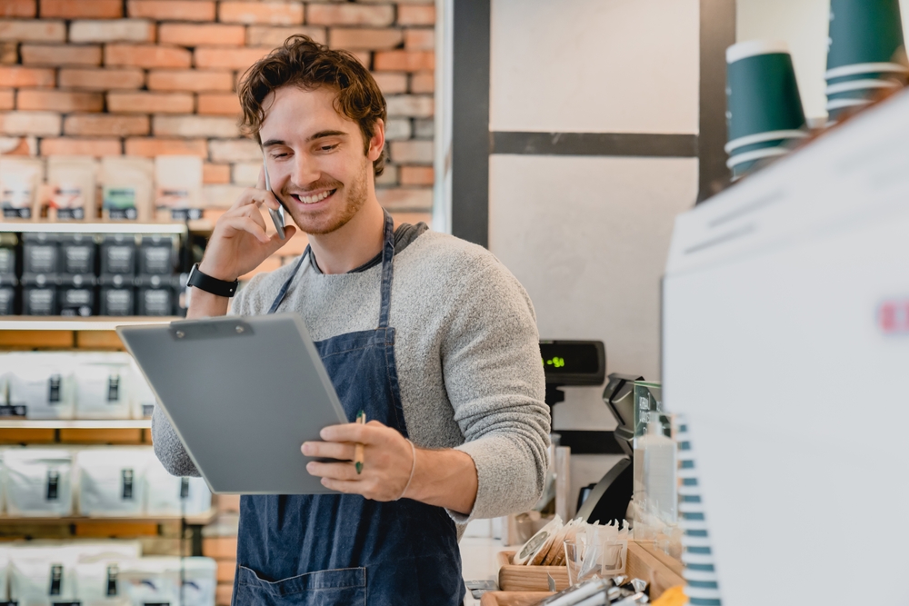 Restaurant manager using the best phone system for restaurants powered by Clear Clouds to manage orders and customer calls