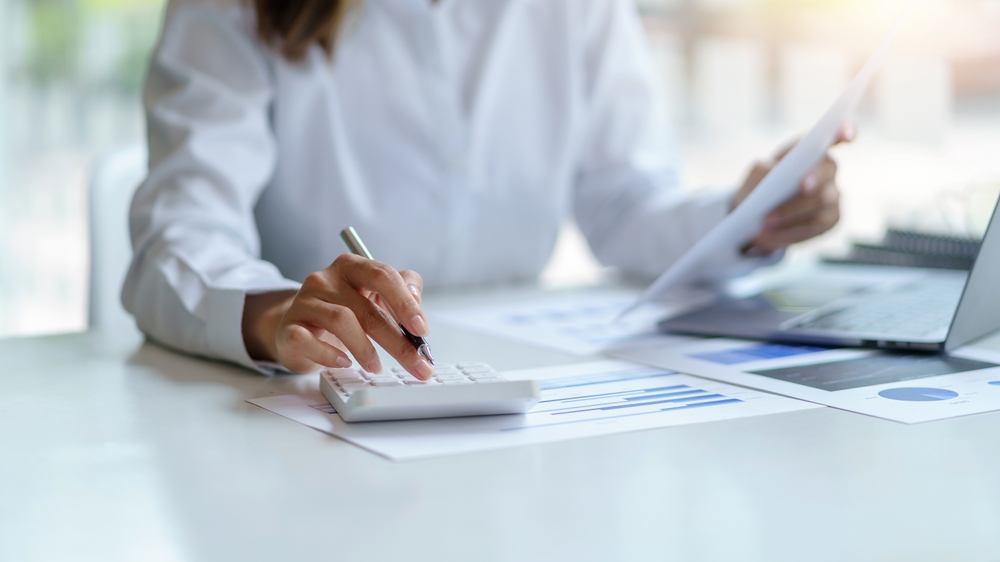 Finance manager auditing telecom bills and service data—showcasing telecom expense management best practices.