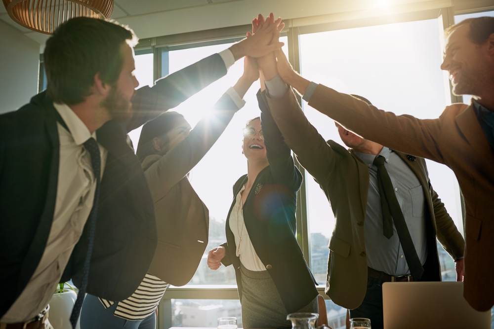 Business team celebrating success after switching from Altima Telecom to SE Telecom’s ClearClouds platform.