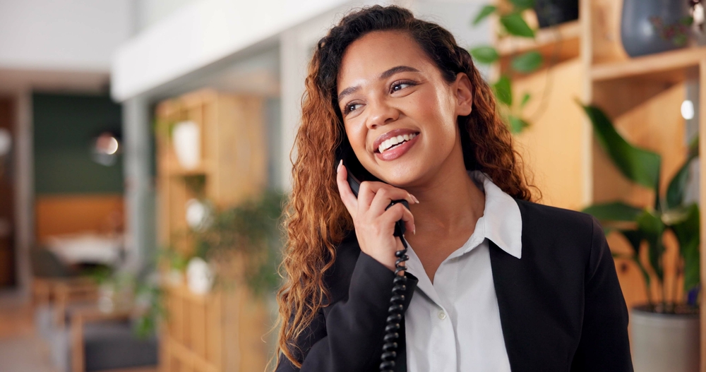 Front desk manager relying on Clear Clouds and the best hotel phone systems in Canada to deliver seamless guest service and support.