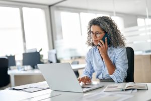 IT leader researching what is Microsoft Direct Routing while managing calls through Microsoft Teams Direct Routing on her laptop.