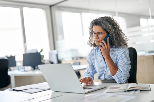 IT leader exploring what is Microsoft Direct Routing while managing calls and collaboration through Microsoft Teams Direct Routing on her laptop.
