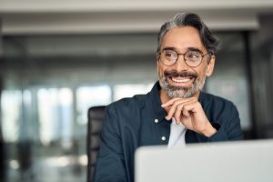 Confident business owner reviewing Clear Clouds as a business phone system Canada alternative to traditional Canadian telecom companies.