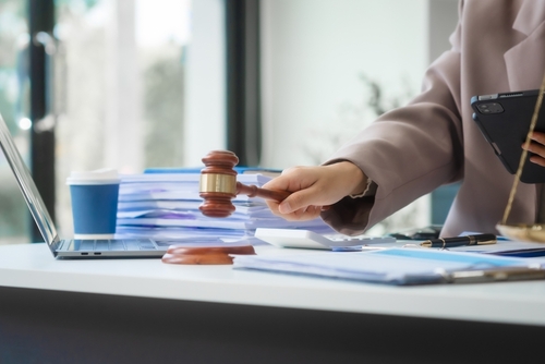 Lawyer reviewing documents on a tablet in an office, demonstrating how voip for law firms supports secure and flexible communication.