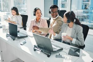 Customer service team working together with headsets in a modern office, representing a voip solutions provider in brampton offering reliable voip canada communication services.