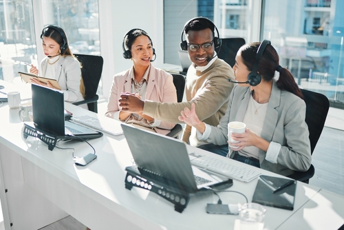Customer service team working together with headsets in a modern office, representing a voip solutions provider in brampton offering reliable voip canada communication services.