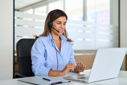 Business professional using a VoIP in Toronto solution on a laptop, demonstrating cloud-based communication and UCaaS capabilities in a modern office.