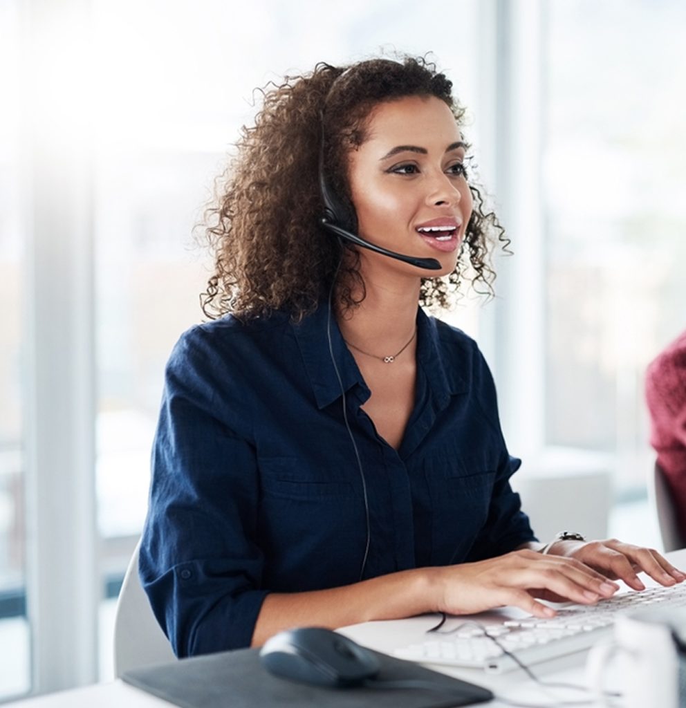 Team of professionals working on computers with headsets, showcasing a cloud business phone system and VoIP business phone in Canada by Clear Clouds.