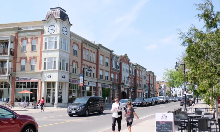 Street-level view of Main Street Markham with shops and pedestrians, illustrating the local business community served by a voip provider in markham.
