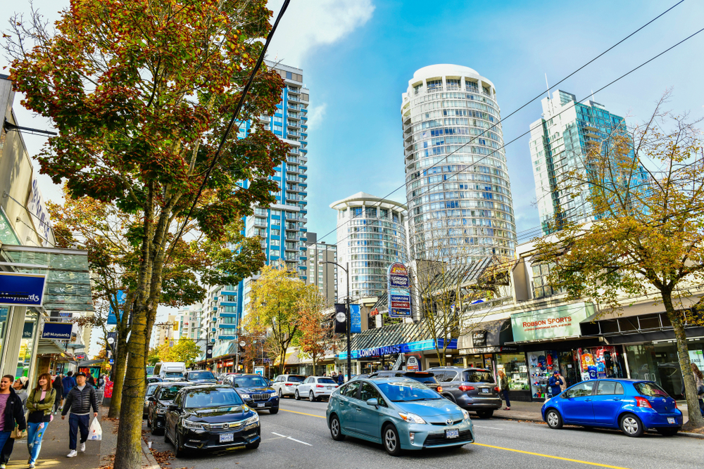 Busy downtown Vancouver street with shops and high-rise buildings, symbolizing BC businesses evaluating hosted VoIP in Vancouver Island and Canadian-hosted phone systems.