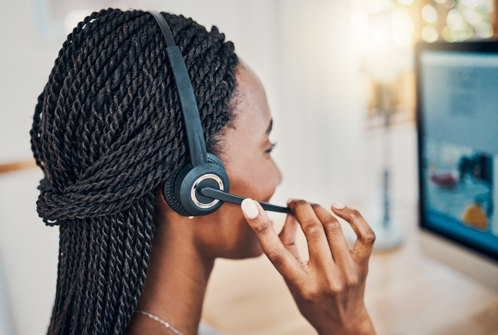 Customer service agent using a cloud phone system headset, representing modern Chicago business VoIP communication for hybrid and remote teams.
