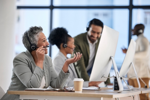 Senior professional using cloud phone systems Toronto powered by SE Telecom in a corporate office setting