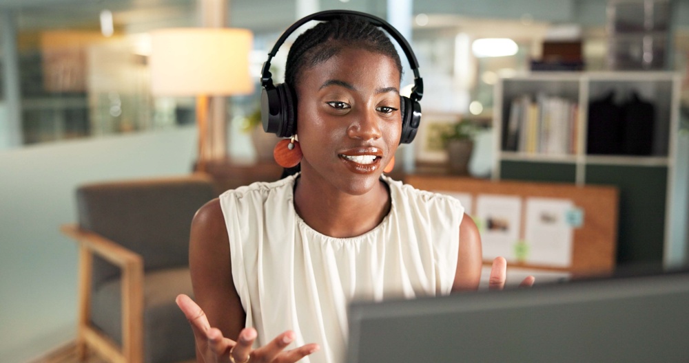 Toronto professional using SE Telecom VoIP phone system Toronto headset and laptop during multi-location business call in modern office