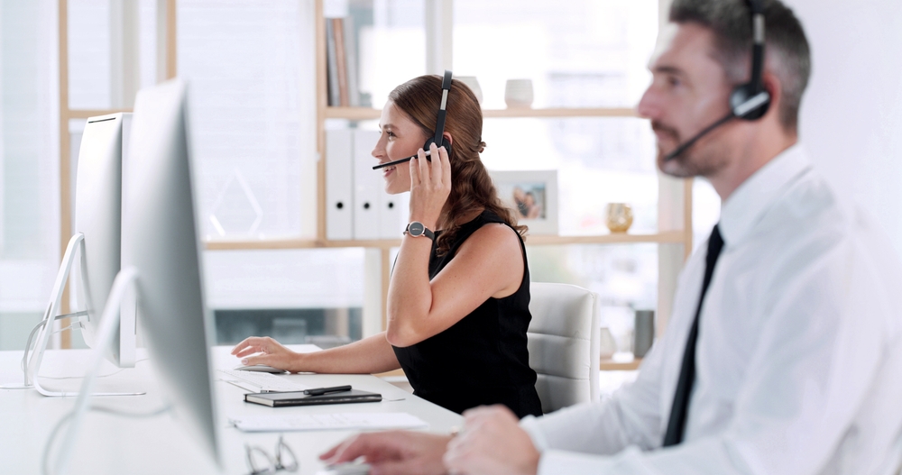 Vancouver business team using SE Telecom business VoIP services in Vancouver with headsets at corporate workstations