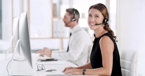 SE Telecom business VoIP services in Vancouver smiling professional on cloud phone system in a modern Vancouver office environment