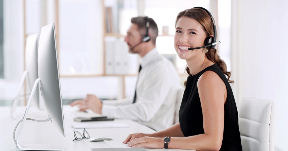 SE Telecom business VoIP services in Vancouver smiling professional on cloud phone system in a modern Vancouver office environment