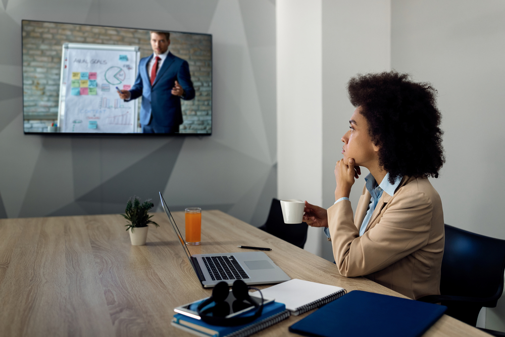 Operations leader evaluating if SE Telecom can Microsoft Teams replace a phone system while attending a virtual business presentation in a Canadian office