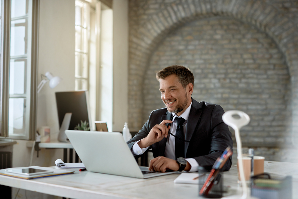 Canadian business professional evaluating telecommunications Canada spend reduction options with SE Telecom platform at his desk
