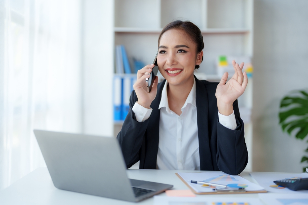Canadian business professional smiling on a call after switching to SE Telecom one of the leading telecommunications providers in Canada