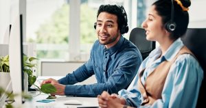 Canadian SE Telecom telecommunications providers Canada team member smiling while managing UCaaS platform deployment from a corporate office