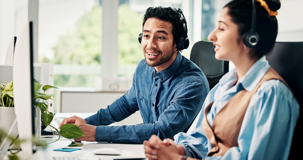 Canadian SE Telecom telecommunications providers Canada team member smiling while managing UCaaS platform deployment from a corporate office