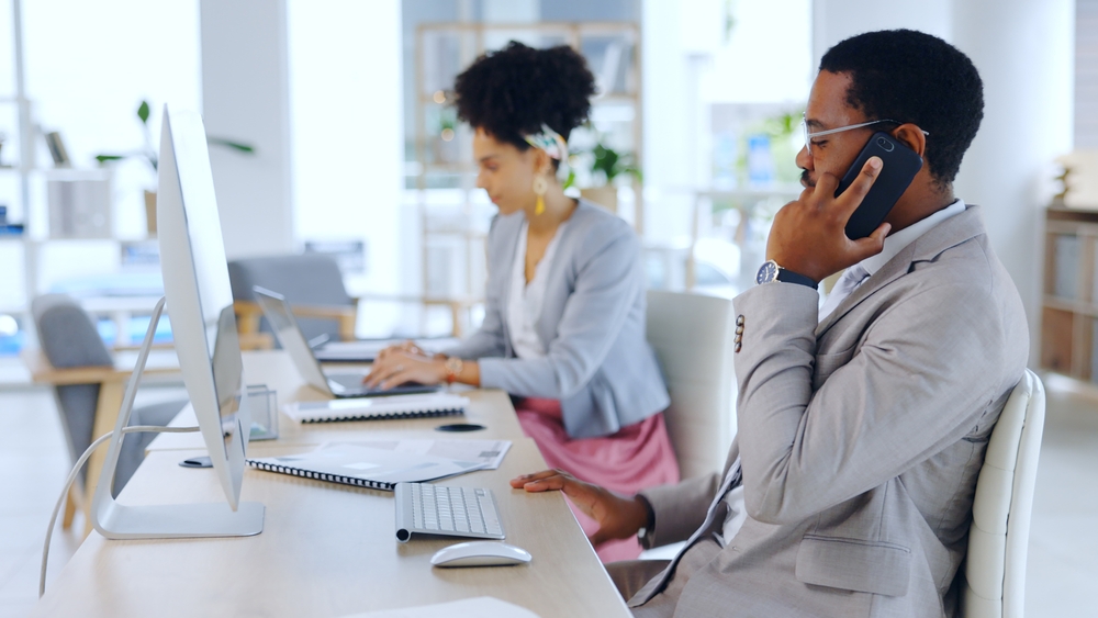 Business professionals in an office, talking on the phone