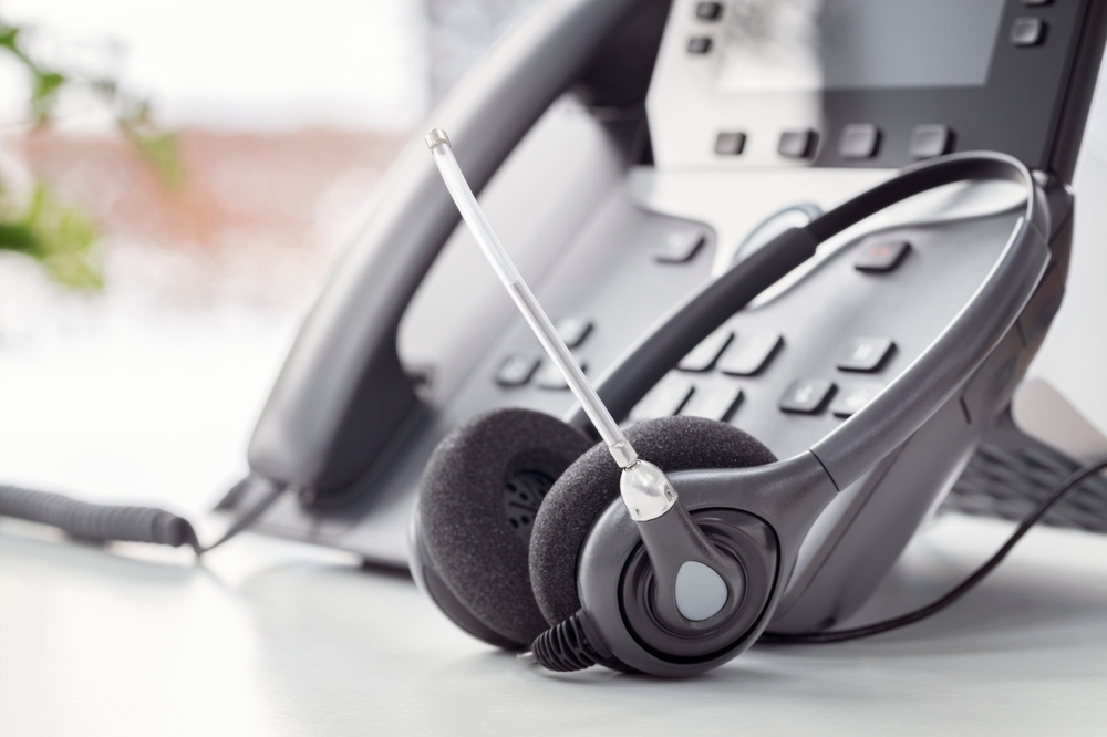 Contemporary office phone system with a wireless headset showcasing VoIP Halifax solutions for seamless business communications.
