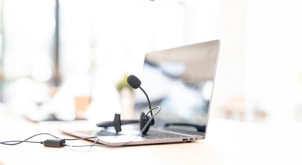Business phone headset and desk telephone representing VoiP Hamilton solutions for professional office communications.