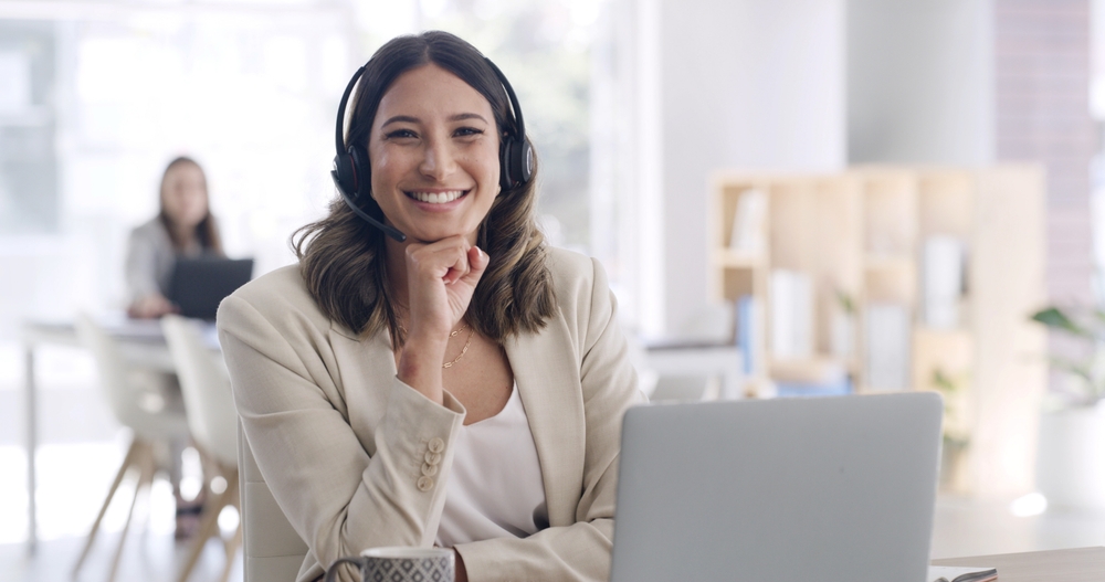 Business professional managing client calls with a headset while using VoIP Surrey for clear and dependable communication.
