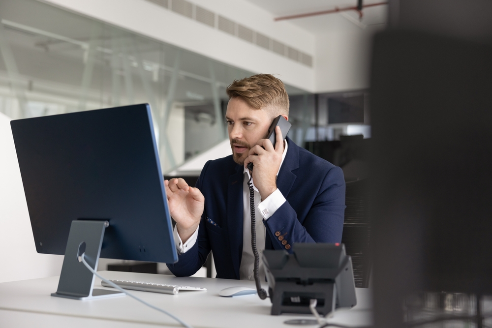 Business professional handling client calls through a headset with quebec voip providers delivering dependable voice services.