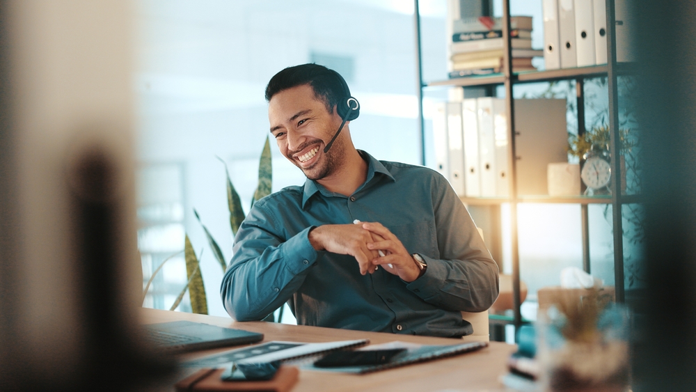 Corporate team member communicating with customers from an office workstation using voip london ontario.