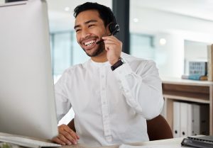 Professional customer service agent taking business calls in a modern office with voip phone service for business in hamilton.
