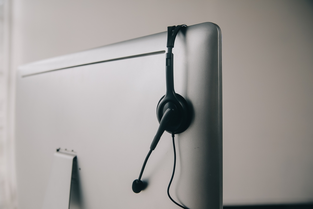 Support representative managing inbound customer calls with a headset and voip quebec business phone services.
