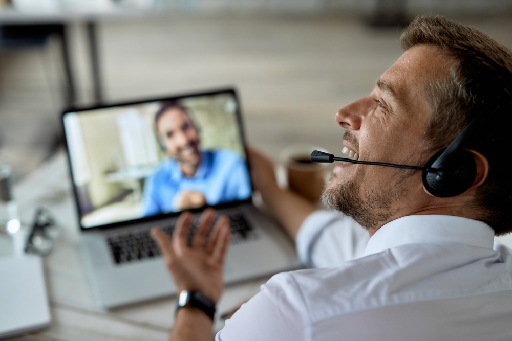 Corporate team member providing customer support from an office workstation using voip quebec communication technology.