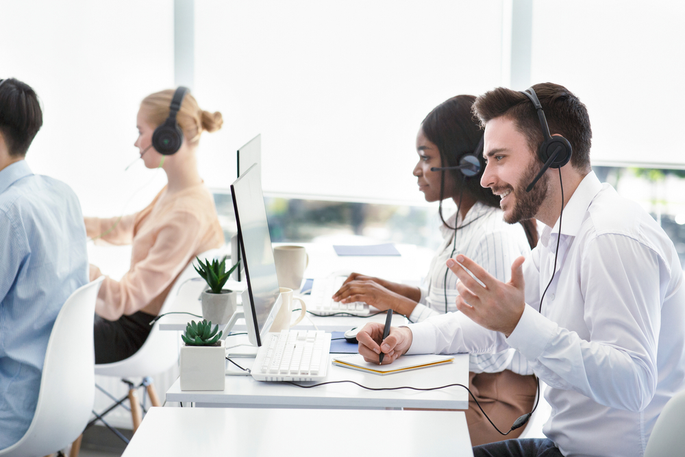 Corporate team member collaborating with customers over the phone using services from Vancouver VoIP Providers to improve productivity and communication.