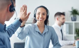 Customer service professional wearing a headset while assisting clients using voip phone Vancouver for reliable business communication.