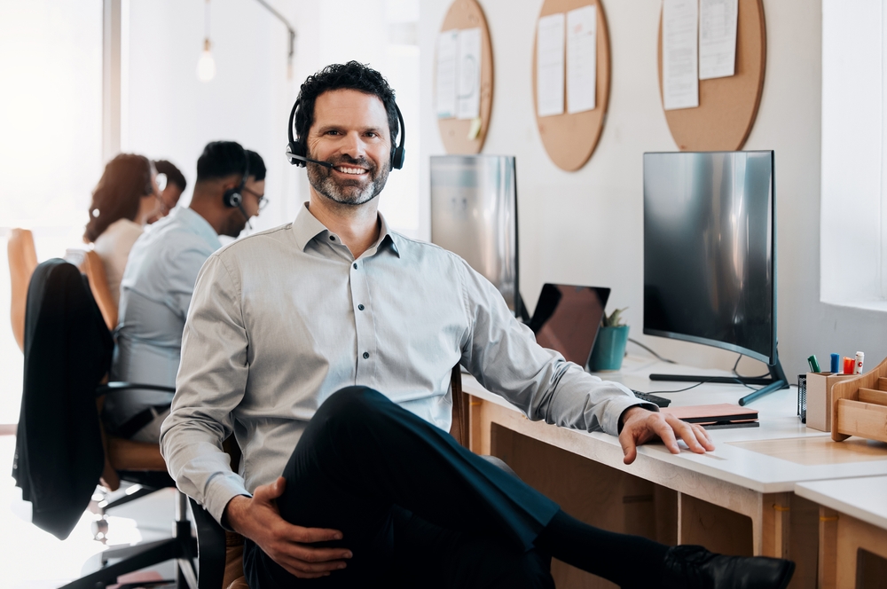 Support representative wearing a headset and handling inbound calls with voip phone Vancouver for seamless customer service.

