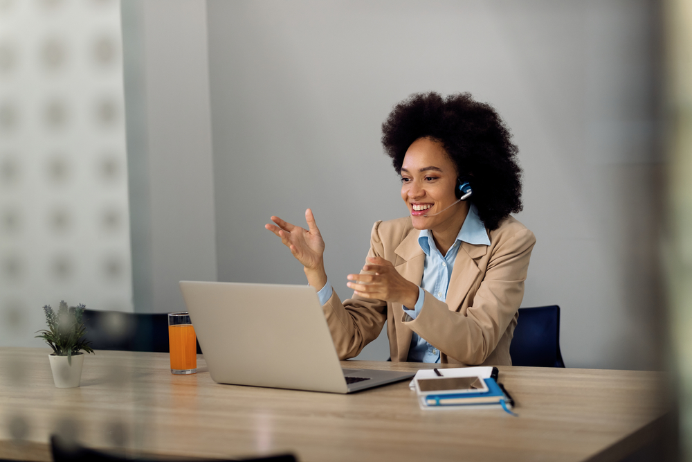 Professional answering business calls with a wireless headset, demonstrating the benefits of voip phone Vancouver for modern office communication.
