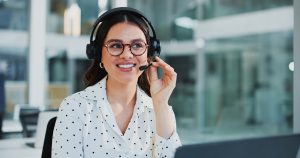 Office professional wearing a headset during a client call after a POTS line replacement project
