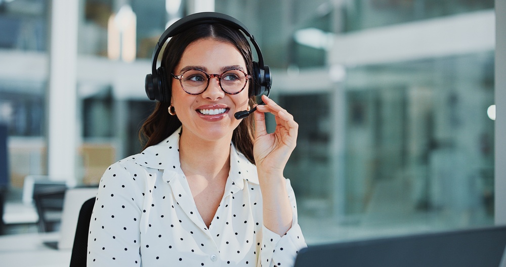 Office professional wearing a headset during a client call after a POTS line replacement project