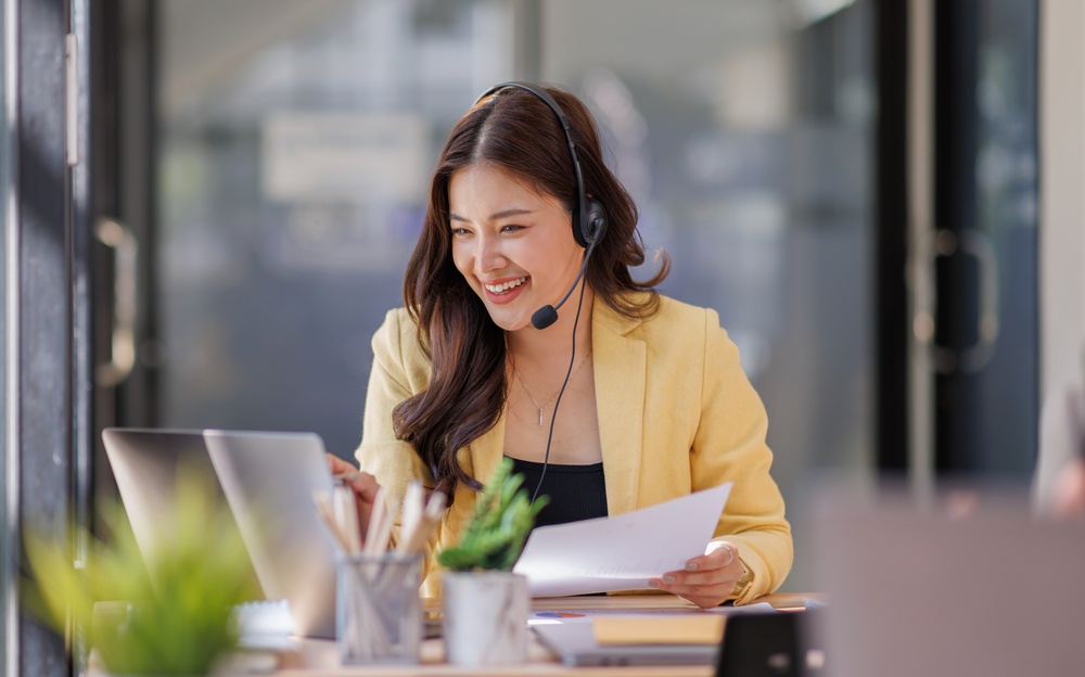 Customer service agent on a headset answering calls on a cloud phone system after POTS line replacement