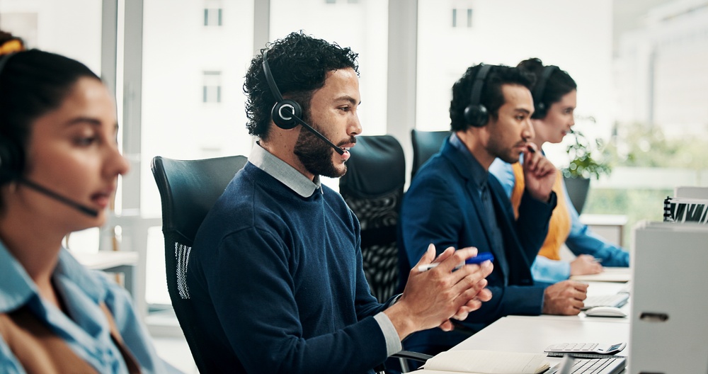 Business team member using a headset and laptop, supported by SE Telecom POTS line replacement