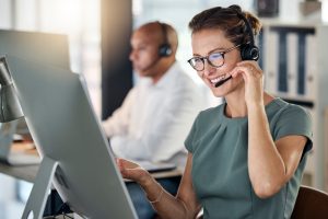 IT professional testing a cloud communications platform setup while wearing a headset