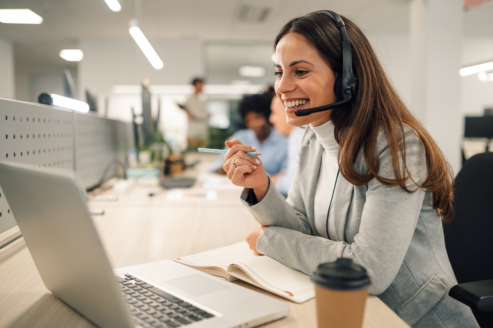 Office worker connecting to a cloud communications platform through a headset and laptop