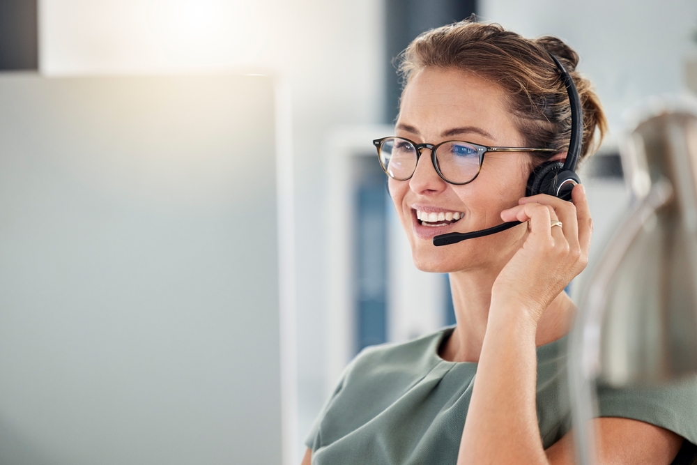 Customer service representative using a headset as part of the company's unified communications solutions

