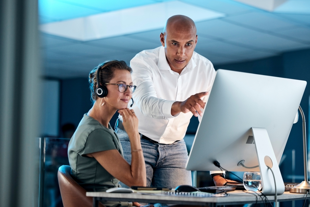 IT professional wearing a headset while testing the company's unified communications solutions setup
